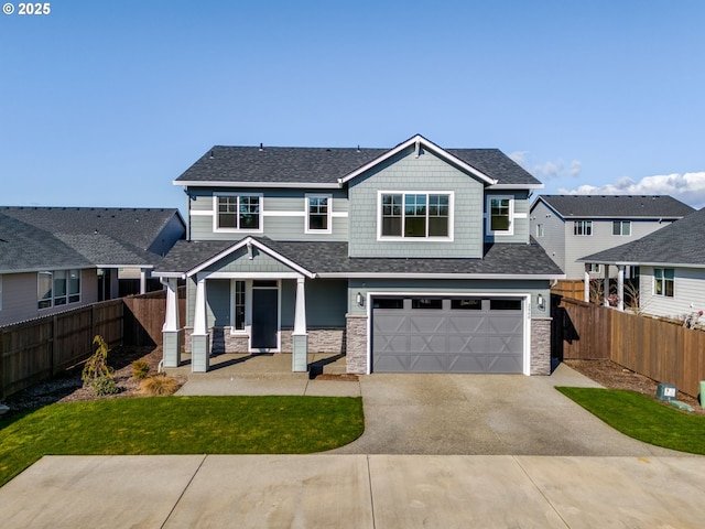 craftsman-style home with driveway, stone siding, fence, a shingled roof, and a garage