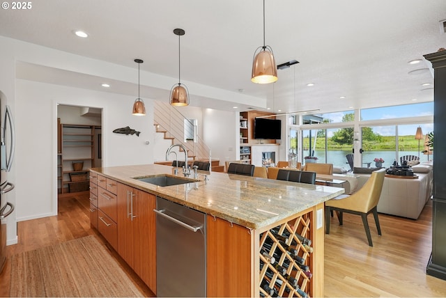 14569 NW Larson Rd Unit 13, Portland, OR 97231 - kitchen with open floor plan, appliances with stainless steel finishes, light wood-type flooring, an island with sink, and recessed lighting