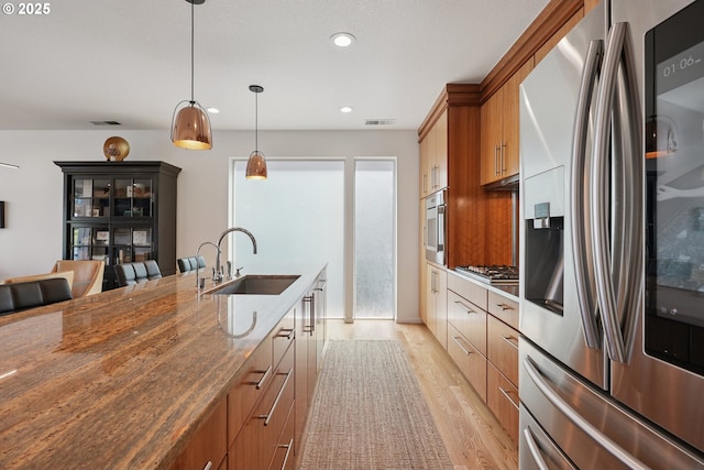14569 NW Larson Rd Unit 13, Portland, OR 97231 - kitchen with appliances with stainless steel finishes, light wood-type flooring, recessed lighting, dark stone counters, and pendant lighting