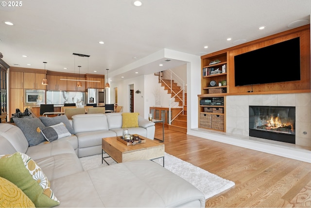 14569 NW Larson Rd Unit 13, Portland, OR 97231 - living room featuring light wood-style floors, stairs, built in shelves, recessed lighting, and a fireplace