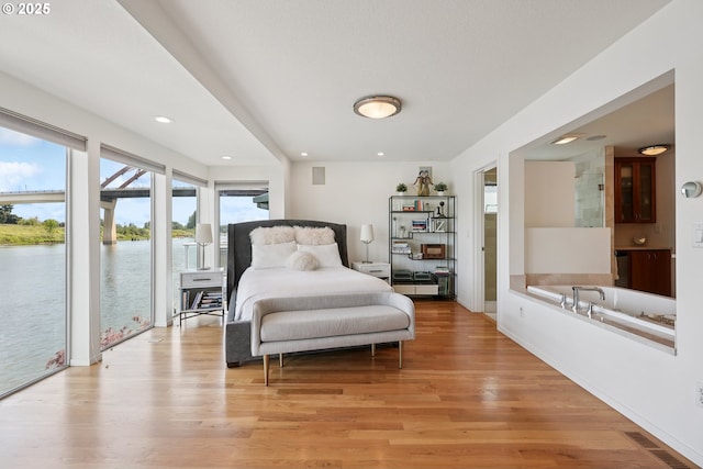 14569 NW Larson Rd Unit 13, Portland, OR 97231 - bedroom with access to outside, light wood finished floors, a water view, and recessed lighting