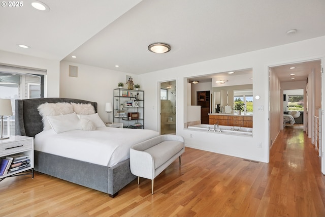 14569 NW Larson Rd Unit 13, Portland, OR 97231 - bedroom with light wood-style floors, recessed lighting, and ensuite bathroom