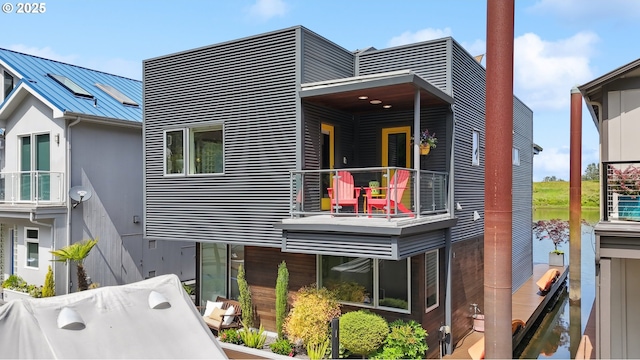 14569 NW Larson Rd Unit 13, Portland, OR 97231 - back of house with a balcony, a standing seam roof, a metal roof, and a water view