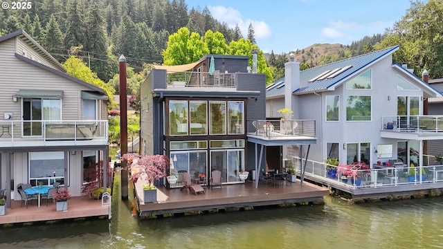 14569 NW Larson Rd Unit 13, Portland, OR 97231 - rear view of property with a chimney, a water view, and a balcony