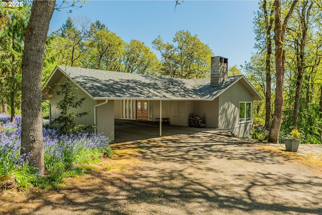 exterior space featuring a carport and driveway