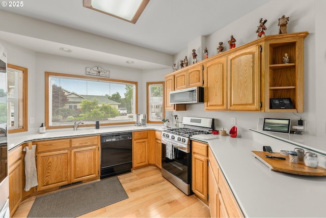 kitchen featuring open shelves, visible vents, stainless steel appliances, light countertops, and light wood-type flooring