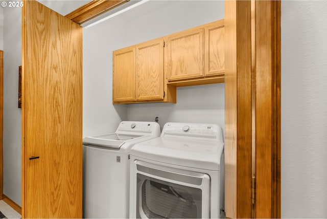 washroom featuring washer and dryer and cabinet space
