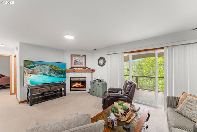living room featuring a tiled fireplace and light colored carpet