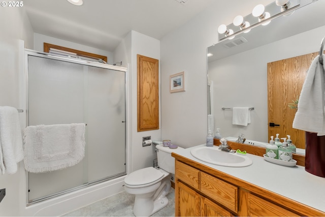 bathroom featuring visible vents, a shower stall, toilet, and vanity