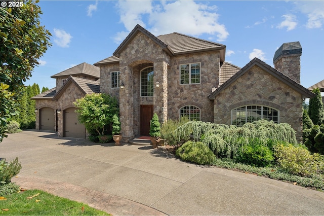 2650 Lorinda Ln, West Linn, OR 97068 - french country inspired facade with stone siding, a garage, driveway, and a tile roof