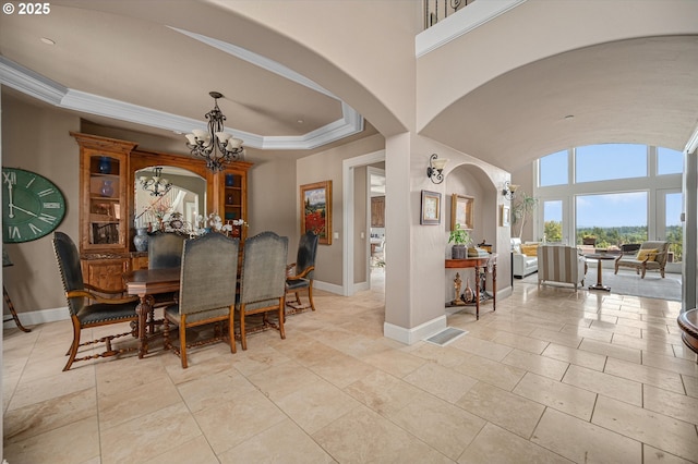 2650 Lorinda Ln, West Linn, OR 97068 - dining space with arched walkways, a chandelier, baseboards, ornamental molding, and a tray ceiling