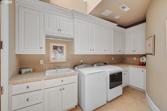 2650 Lorinda Ln, West Linn, OR 97068 - washroom with cabinet space, separate washer and dryer, and light tile patterned floors