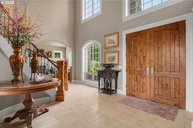 2650 Lorinda Ln, West Linn, OR 97068 - entrance foyer featuring stairs, arched walkways, a towering ceiling, and baseboards