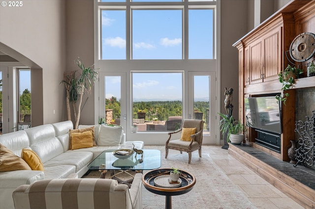 2650 Lorinda Ln, West Linn, OR 97068 - living room with stone tile floors, a towering ceiling, and plenty of natural light