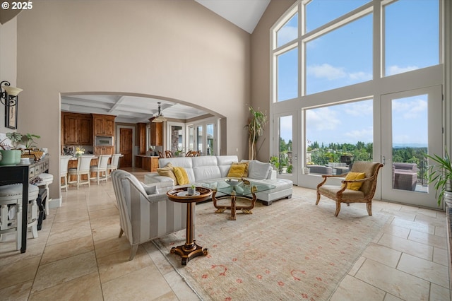 2650 Lorinda Ln, West Linn, OR 97068 - living area with arched walkways, high vaulted ceiling, coffered ceiling, beam ceiling, and ceiling fan