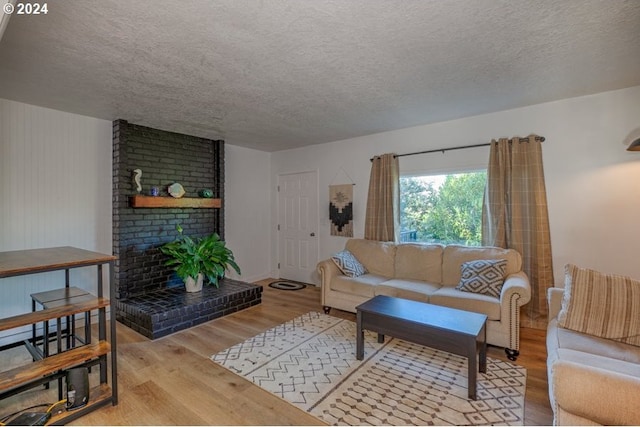 10391041 NE Grant St, Newport, OR 97365 - living room with wood finished floors, a textured ceiling, and a fireplace