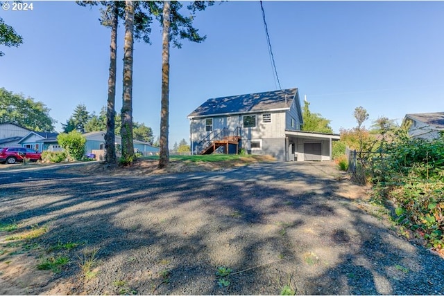 10391041 NE Grant St, Newport, OR 97365 - view of front of house featuring stairs, a carport, and driveway