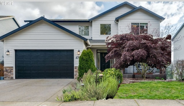 4762 Z St, Washougal, WA 98671 - view of front of house with concrete driveway, an attached garage, and stone siding