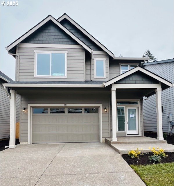 craftsman-style house with a garage, french doors, and driveway