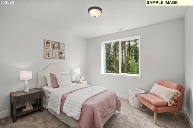 carpeted bedroom featuring visible vents and baseboards