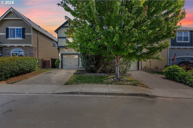 3504 NE Garfield St, Camas, WA 98607 - obstructed view of property with an attached garage, driveway, and stone siding