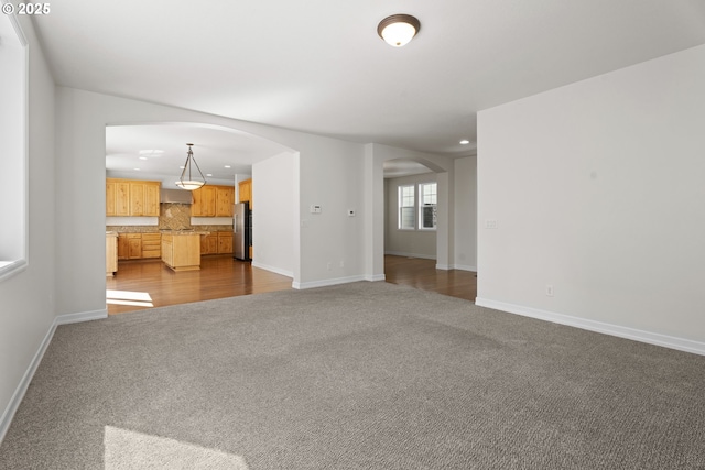 3504 NE Garfield St, Camas, WA 98607 - unfurnished living room featuring arched walkways, dark carpet, and recessed lighting