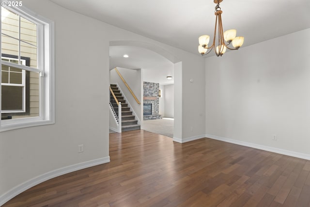 3504 NE Garfield St, Camas, WA 98607 - empty room with arched walkways, wood finished floors, stairway, and a chandelier