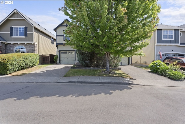 3504 NE Garfield St, Camas, WA 98607 - view of front facade featuring driveway, a garage, and stone siding