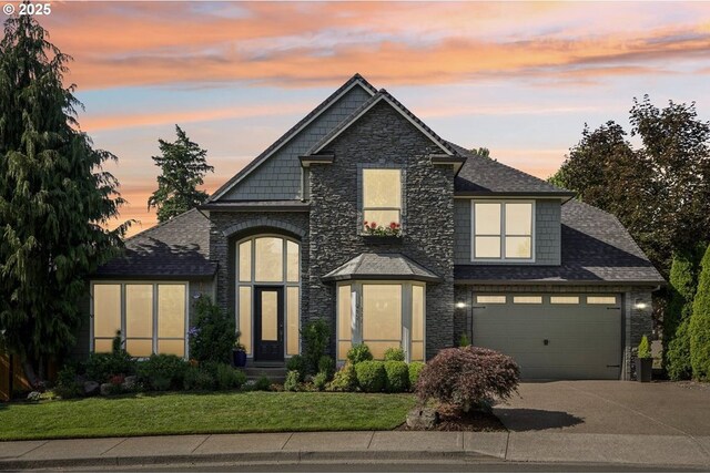 915 NE 36th Ave, Camas, WA 98607 - view of front of house featuring stone siding, concrete driveway, a front lawn, and a shingled roof