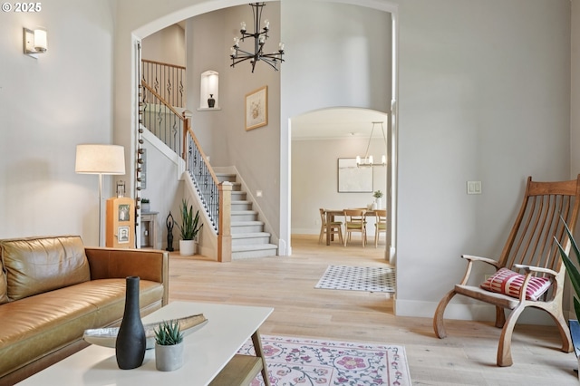 915 NE 36th Ave, Camas, WA 98607 - living room with a chandelier, arched walkways, wood finished floors, stairway, and a towering ceiling