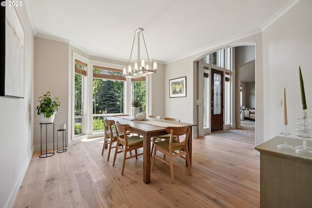 915 NE 36th Ave, Camas, WA 98607 - dining room with arched walkways, light wood-style flooring, crown molding, and a chandelier