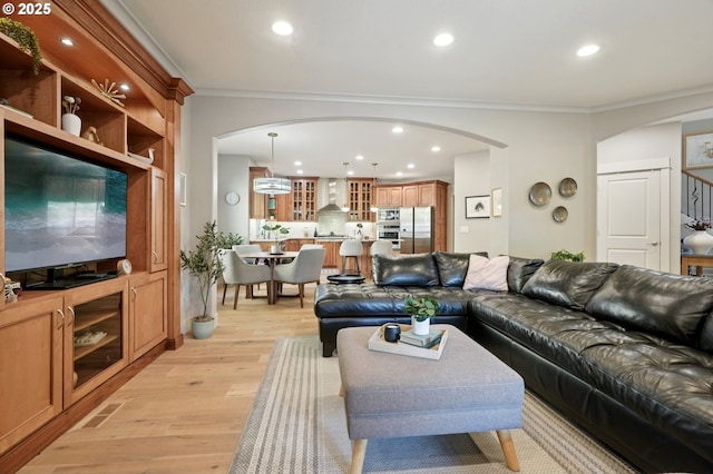 915 NE 36th Ave, Camas, WA 98607 - living area with arched walkways, crown molding, light wood-style flooring, and recessed lighting
