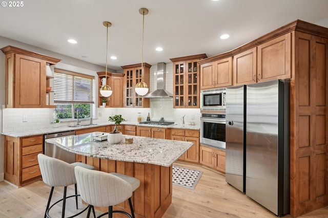915 NE 36th Ave, Camas, WA 98607 - kitchen featuring appliances with stainless steel finishes, wall chimney range hood, open shelves, light wood-style flooring, and decorative backsplash