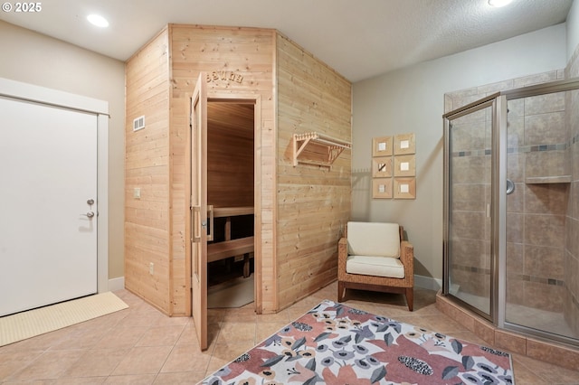 915 NE 36th Ave, Camas, WA 98607 - bathroom featuring wood walls, a stall shower, tile patterned flooring, and recessed lighting