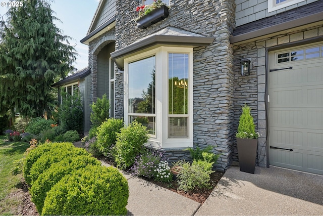 915 NE 36th Ave, Camas, WA 98607 - property entrance with stone siding, a high end roof, and an attached garage