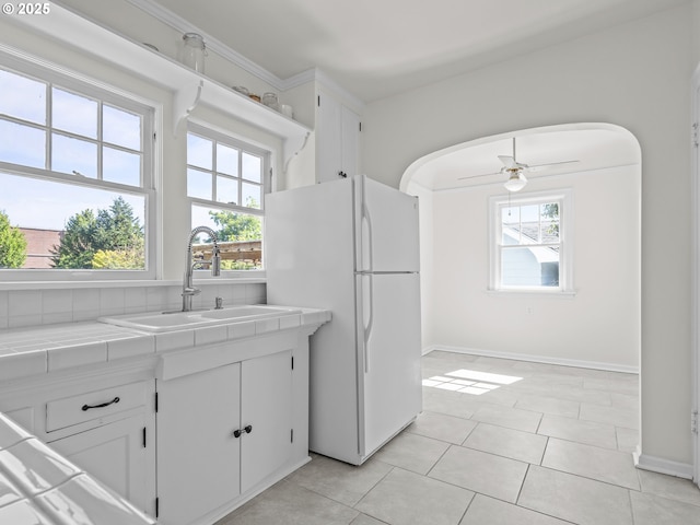 3310 NE 70th Ave, Portland, OR 97213 - kitchen with tile counters, freestanding refrigerator, a sink, and healthy amount of natural light
