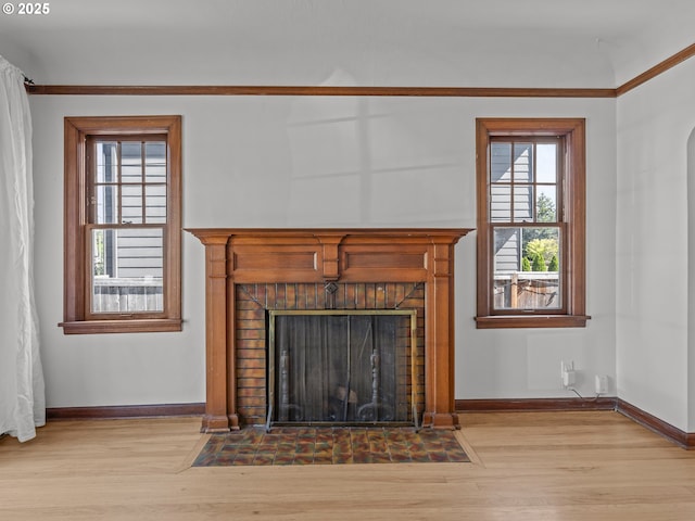 3310 NE 70th Ave, Portland, OR 97213 - detailed view of a brick fireplace, wood finished floors, baseboards, and crown molding