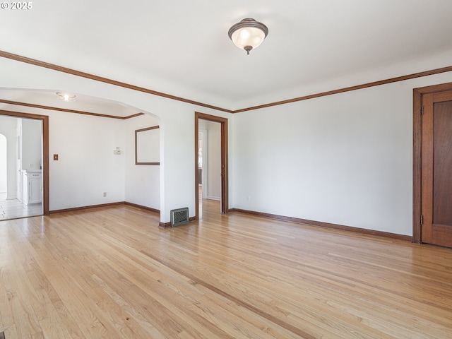 3310 NE 70th Ave, Portland, OR 97213 - empty room with arched walkways, light wood-style floors, baseboards, and ornamental molding