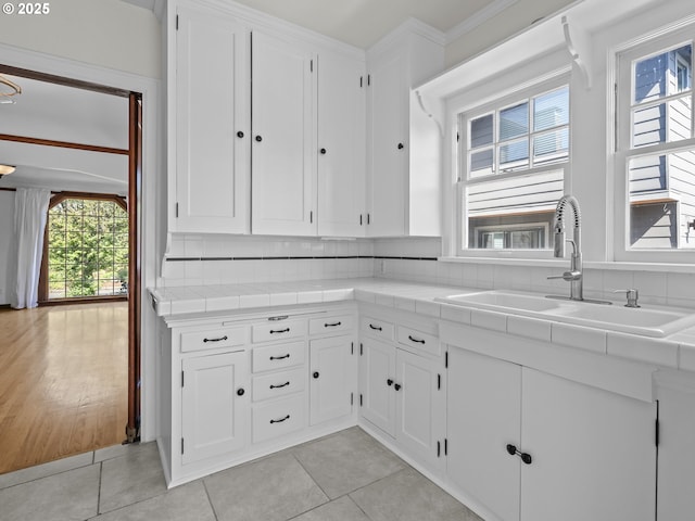 3310 NE 70th Ave, Portland, OR 97213 - kitchen with a sink, tile countertops, white cabinetry, and light tile patterned floors