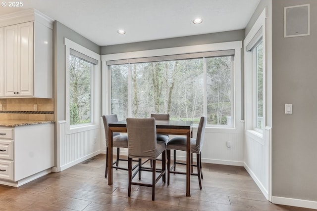 dining room featuring recessed lighting, wainscoting, visible vents, and wood finished floors