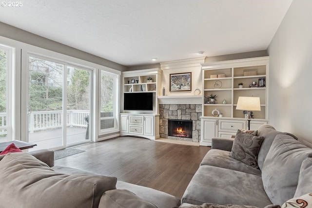 living room with a fireplace and dark wood-type flooring