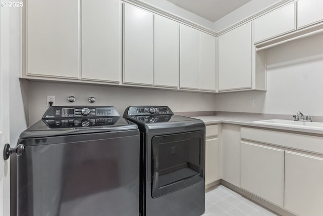 laundry area with a sink, cabinet space, and washer and dryer