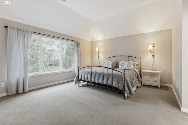 carpeted bedroom with baseboards and vaulted ceiling