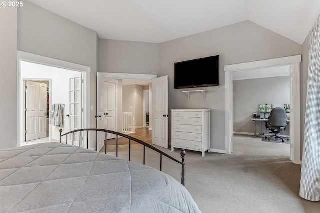 bedroom with lofted ceiling, carpet flooring, and baseboards