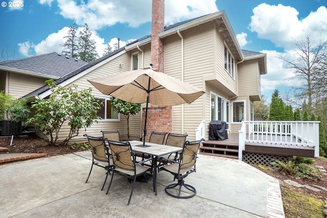 view of patio featuring outdoor dining area, grilling area, and a wooden deck