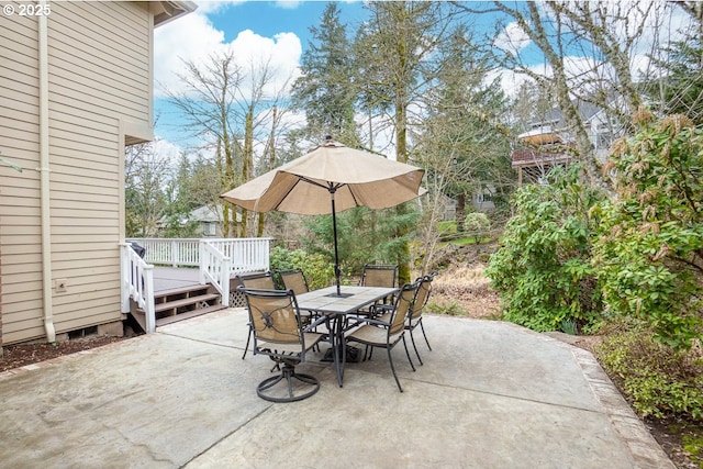 view of patio / terrace featuring a deck and outdoor dining space