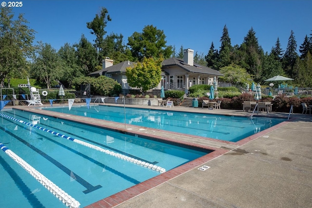 pool featuring a patio and fence