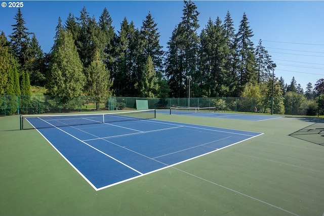 view of sport court featuring fence