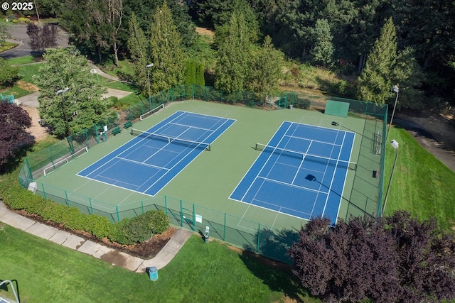 view of sport court featuring a yard and fence