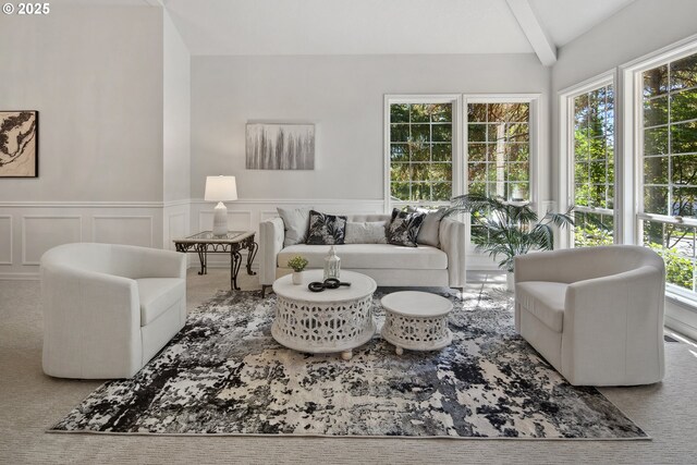 living room featuring beam ceiling and carpet flooring